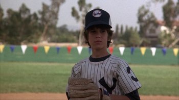 Movie still from “The Bad News Bears” (1976), directed by Michael Ritchie – A young baseball player holding a ball and a mitt; Close Up shot, Over the shoulder angle