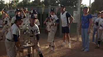 Movie still from “The Bad News Bears” (1976), directed by Michael Ritchie – A group of young baseball players standing next to each other on a baseball field; Wide shot, Low angle