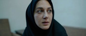 Movie still from “Holy Spider” (2022), directed by Ali Abbasi – A person wearing a black headscarf; Close Up shot, Over the shoulder angle