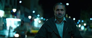 Movie still from “Holy Spider” (2022), directed by Ali Abbasi – A person wearing a jacket on a city street; Close Up shot, Low angle