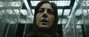 Movie still from “Holy Spider” (2022), directed by Ali Abbasi – A person wearing a head scarf; Close Up shot, Low angle