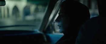 Movie still from “Holy Spider” (2022), directed by Ali Abbasi – A woman sitting in a car looking out of the window; Close Up shot, Over the shoulder angle