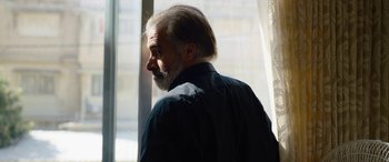 Movie still from “Holy Spider” (2022), directed by Ali Abbasi – A man standing in front of a window with a beard; Close Up shot, Low angle