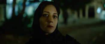 Movie still from “Holy Spider” (2022), directed by Ali Abbasi – A person wearing a headscarf; Close Up shot, Low angle