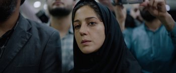 Movie still from “Holy Spider” (2022), directed by Ali Abbasi – A person wearing a black headscarf; Close Up shot, Over the shoulder angle