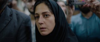 Movie still from “Holy Spider” (2022), directed by Ali Abbasi – A person wearing a head scarf; Close Up shot, Over the shoulder angle