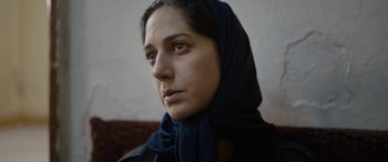 Movie still from “Holy Spider” (2022), directed by Ali Abbasi – A person wearing a headscarf; Close Up shot, Low angle