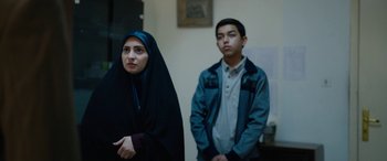 Movie still from “Holy Spider” (2022), directed by Ali Abbasi – A woman and a man standing next to each other; Medium shot, Over the shoulder angle