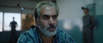 Movie still from “Holy Spider” (2022), directed by Ali Abbasi – A person with a beard; Close Up shot, Over the shoulder angle