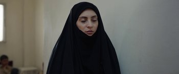 Movie still from “Holy Spider” (2022), directed by Ali Abbasi – A woman in a black veil is looking at the camera; Close Up shot, Low angle