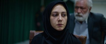 Movie still from “Holy Spider” (2022), directed by Ali Abbasi – A person wearing a black headscarf; Close Up shot, Over the shoulder angle