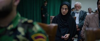 Movie still from “Holy Spider” (2022), directed by Ali Abbasi – A woman in a black hijab is holding a cell phone; Close Up shot, Over the shoulder angle