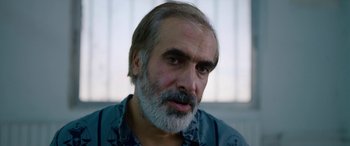 Movie still from “Holy Spider” (2022), directed by Ali Abbasi – A person with a beard; Close Up shot, Over the shoulder angle