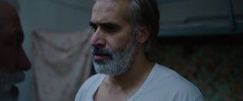 Movie still from “Holy Spider” (2022), directed by Ali Abbasi – A person with a beard; Close Up shot, Over the shoulder angle