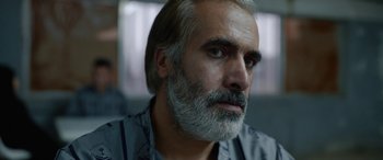 Movie still from “Holy Spider” (2022), directed by Ali Abbasi – A person with a beard; Close Up shot, Over the shoulder angle