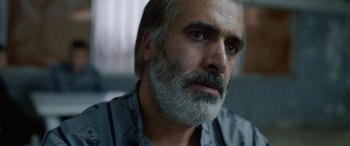 Movie still from “Holy Spider” (2022), directed by Ali Abbasi – A person with a beard; Close Up shot, Over the shoulder angle