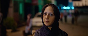 Movie still from “Holy Spider” (2022), directed by Ali Abbasi – A person wearing a headscarf; Close Up shot, Over the shoulder angle