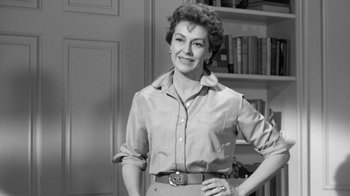 Movie still from “The Bad Seed” (1956), directed by Mervyn LeRoy – An older woman standing in front of a book shelf; Medium shot, Low angle