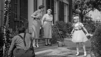 Movie still from “The Bad Seed” (1956), directed by Mervyn LeRoy – A black and white photo of two women and a little girl; Wide shot, Over the shoulder angle