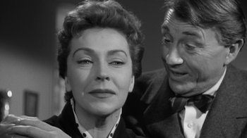 Movie still from “The Bad Seed” (1956), directed by Mervyn LeRoy – An old photo of a man and a woman; Close Up shot, Over the shoulder angle
