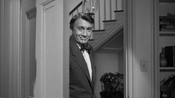 Movie still from “The Bad Seed” (1956), directed by Mervyn LeRoy – A black and white photo of a man in a suit; Medium shot, Low angle