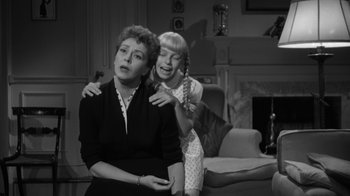 Movie still from “The Bad Seed” (1956), directed by Mervyn LeRoy – A woman and a girl in a living room; Medium shot, High angle