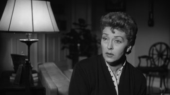 Movie still from “The Bad Seed” (1956), directed by Mervyn LeRoy – An old photo of a woman in a black jacket; Close Up shot, Low angle