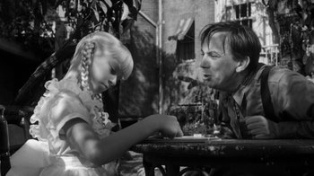 Movie still from “The Bad Seed” (1956), directed by Mervyn LeRoy – An old photo of a man and a little girl; Close Up shot, Over the shoulder angle