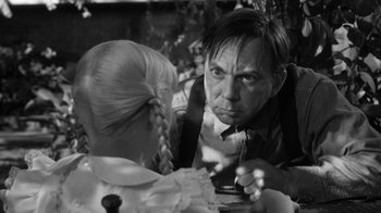 Movie still from “The Bad Seed” (1956), directed by Mervyn LeRoy – A black and white photo of a man and a girl; Close Up shot, Over the shoulder angle