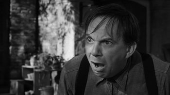 Movie still from “The Bad Seed” (1956), directed by Mervyn LeRoy – Black and white photograph of a man making an angry face; Close Up shot, Low angle