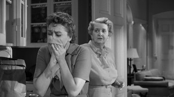 Movie still from “The Bad Seed” (1956), directed by Mervyn LeRoy – Two women are standing in front of each other; Medium shot, Over the shoulder angle