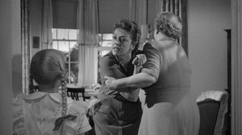 Movie still from “The Bad Seed” (1956), directed by Mervyn LeRoy – Two women are dancing in an old fashion setting; Medium shot, Over the shoulder angle