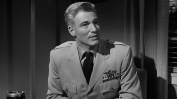 Movie still from “The Bad Seed” (1956), directed by Mervyn LeRoy – A man in a military uniform is looking to his left; Close Up shot, Low angle