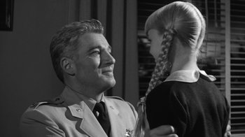 Movie still from “The Bad Seed” (1956), directed by Mervyn LeRoy – An old photo of a man and a little girl; Close Up shot, Low angle