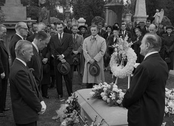 Movie still from “The Bad and the Beautiful” (1952), directed by Vincente Minnelli – A group of people standing around a grave; Wide shot, High angle