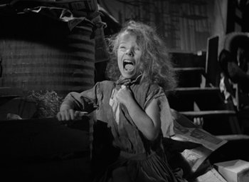 Movie still from “The Bad and the Beautiful” (1952), directed by Vincente Minnelli – A little girl with curly red hair is crying; Medium shot, Low angle