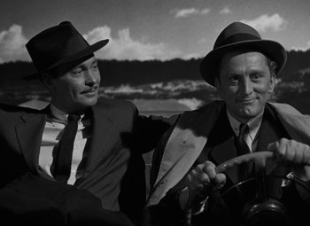 Movie still from “The Bad and the Beautiful” (1952), directed by Vincente Minnelli – A couple of men sitting next to each other on top of a boat; Close Up shot, High angle