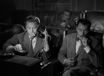 Movie still from “The Bad and the Beautiful” (1952), directed by Vincente Minnelli – A group of men sitting in a room; Medium shot, High angle
