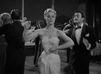 Movie still from “The Bad and the Beautiful” (1952), directed by Vincente Minnelli – A black and white photo of a woman in a dress; Medium shot, Low angle