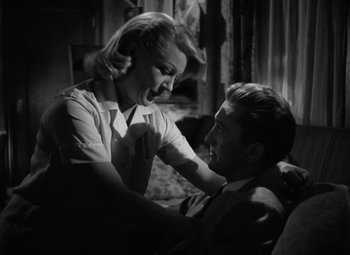 Movie still from “The Bad and the Beautiful” (1952), directed by Vincente Minnelli – A man and a woman sitting on a couch together; Close Up shot, Low angle