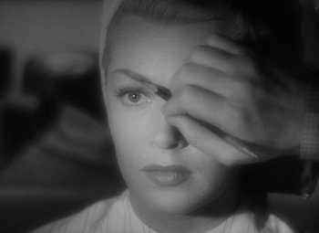 Movie still from “The Bad and the Beautiful” (1952), directed by Vincente Minnelli – A black - and - white photo of a woman's face; Extreme Close Up shot, Over the shoulder angle