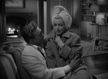 Movie still from “The Bad and the Beautiful” (1952), directed by Vincente Minnelli – A man and a woman are sitting together in a living room; Medium shot, High angle