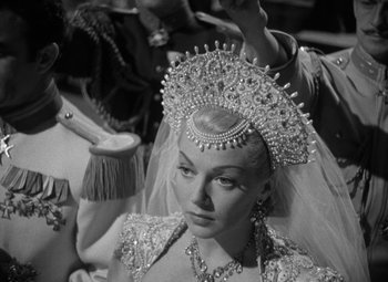 Movie still from “The Bad and the Beautiful” (1952), directed by Vincente Minnelli – A black and white photo of a woman wearing a tiara; Close Up shot, Over the shoulder angle