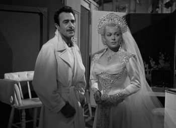 Movie still from “The Bad and the Beautiful” (1952), directed by Vincente Minnelli – A black and white photo of a man and a woman; Medium shot, Over the shoulder angle