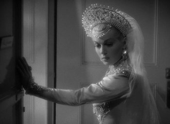 Movie still from “The Bad and the Beautiful” (1952), directed by Vincente Minnelli – A woman in a white dress and a tiara; Close Up shot, Over the shoulder angle