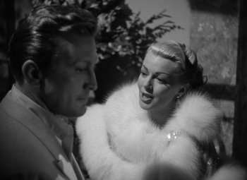 Movie still from “The Bad and the Beautiful” (1952), directed by Vincente Minnelli – A man and a woman in a white fur coat; Close Up shot, Low angle