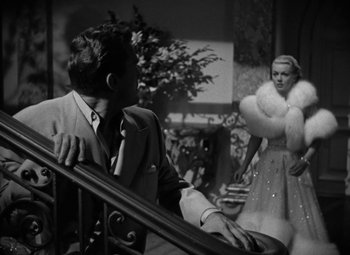 Movie still from “The Bad and the Beautiful” (1952), directed by Vincente Minnelli – A black and white photo of a man and a woman; Medium shot, Low angle