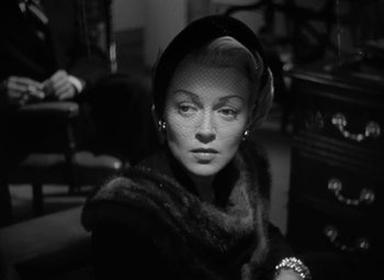 Movie still from “The Bad and the Beautiful” (1952), directed by Vincente Minnelli – A black and white photo of a woman wearing a veil; Close Up shot, Low angle