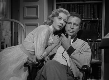 Movie still from “The Bad and the Beautiful” (1952), directed by Vincente Minnelli – An old photo of a man and a woman sitting in a chair; Medium shot, Low angle