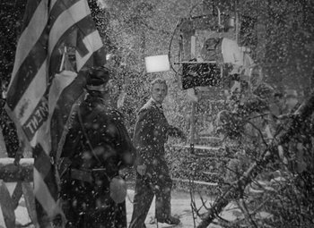 Movie still from “The Bad and the Beautiful” (1952), directed by Vincente Minnelli – A group of people walking through the snow; Wide shot, Low angle